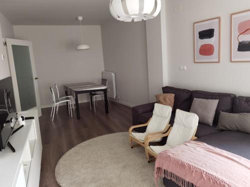 a living room with a couch and chairs and a table at Apartamento Palacio de los Toledo in Corella