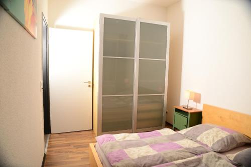 a bedroom with a bed and a glass door at Ferienanlage Markus Nitsch in Bärenstein