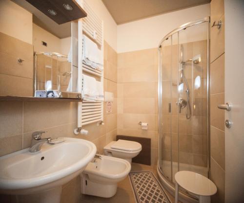 a bathroom with a sink and a toilet and a shower at Albergo Sole in Mariano Comense
