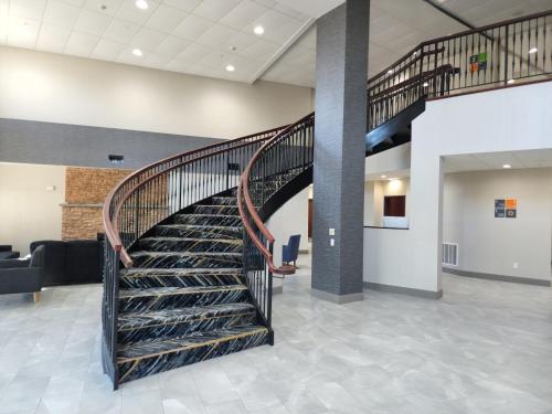 a spiral staircase in a hospital lobby at La Quinta Inn & Suites by Wyndham Lake George in Lake George