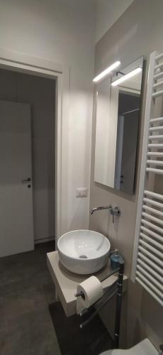 a bathroom with a white sink and a mirror at Vien dal Mare in Bari