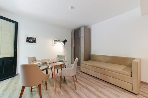 a living room with a table and a couch at Hotel Baia Delle Sirene in Taormina
