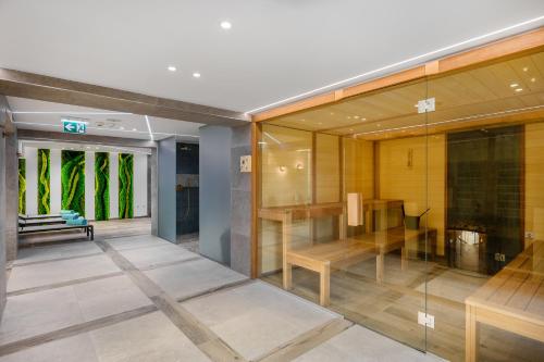 a room with glass walls and a table and a bench at Mercure Tokaj Center in Tokaj