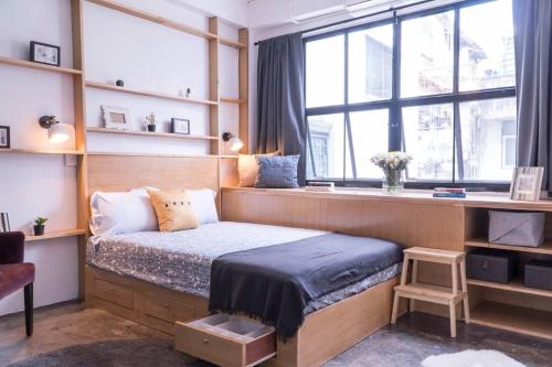 a bedroom with a bed and a desk and windows at Beautiful Super Modern Gigantic Designer Home in Bangkok