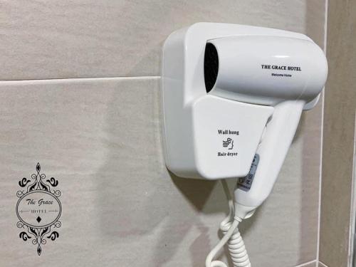 a white hairdryer in a box with a sticker on it at The Grace Hotel in Muar