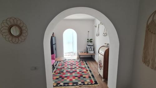 an archway leading into a living room with a rug at Iulia Sulina Deluxe in Sulina