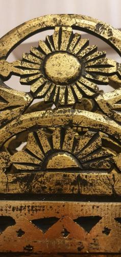 a gold picture of a sun on a wall at Moon's Tower suite&rooms in Portoscuso