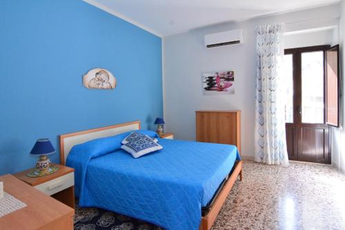 シャッカにあるBilocale Bevilacqua Centralissimo a Sciaccaの青いベッドルーム(ベッド1台、テーブル付)