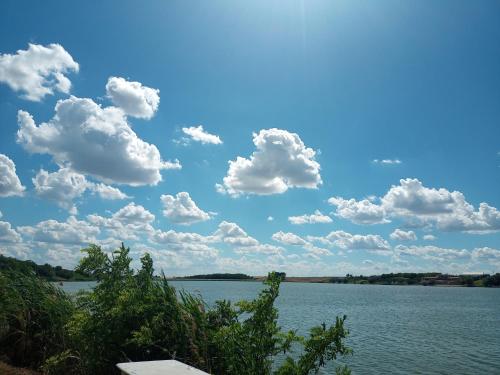 a large body of water with clouds in the sky at Smeštaj Vrhovac in Vrdnik