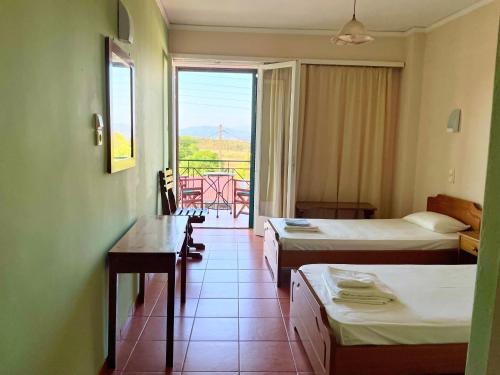 a hotel room with two beds and a balcony at Klitemnistra Rooms in Mykines