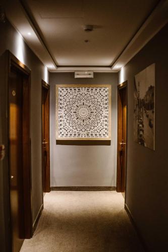 a hallway with a wall with a painting on it at Hotel Loreley in Lido di Jesolo