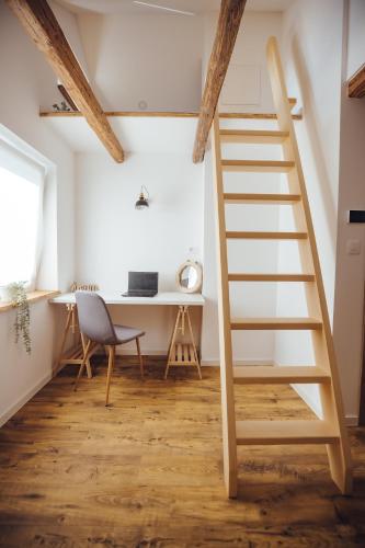 a staircase in a room with a desk and a chair at Drive Caffe Apartments in Trzin