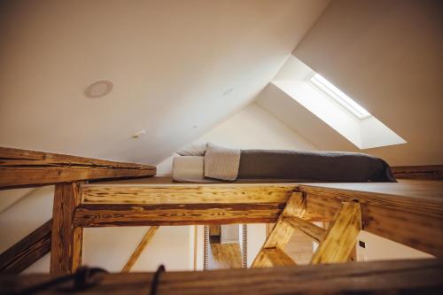 a bed sitting on top of a wooden table at Drive Caffe Apartments in Trzin