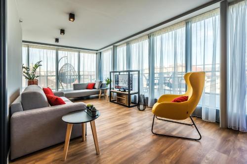 a living room with a couch and a chair at Up Hotel Budapest in Budapest