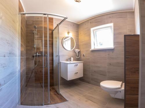 a bathroom with a shower and a toilet and a sink at Willa Panorama in Polańczyk