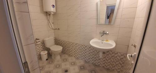 a small bathroom with a sink and a toilet at Villas Chinara in Kranevo