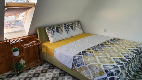 a bedroom with a bed in a room with a window at TOP 3 Apartments in Strumica