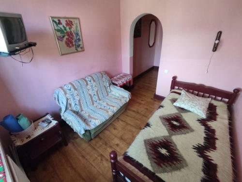 a living room with a bed and a couch at Готель-Маєток in Luts'k