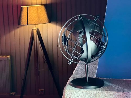 a fan sitting on a table next to a lamp at LoveRoom avec SPA privatif Plélo in Plélo