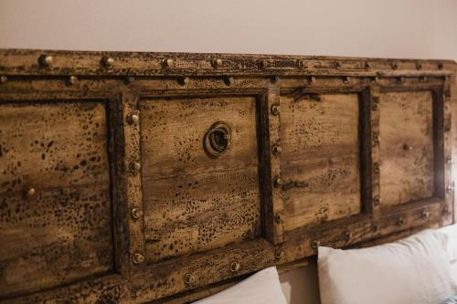an old wooden chest sitting on top of a bed at Moon's Tower suite&rooms in Portoscuso