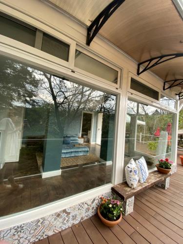 a screened in porch with a bench and plants at Green House by W. in Heredia