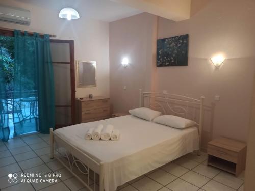 a bedroom with a bed with white pillows on it at Erminia Studios in Mousata