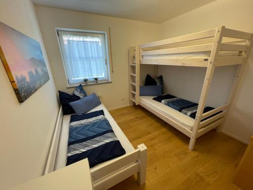a room with two bunk beds and a window at Ferienwohnung Hochriesblick in Samerberg
