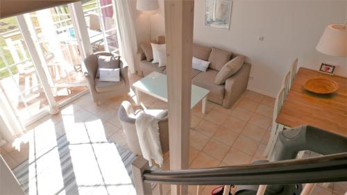 a living room with a couch and a table at Iris Strandhus in Sierksdorf