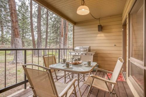 a patio with a table and chairs on a porch at Ski House 155 - Meredith Lodging in Bend