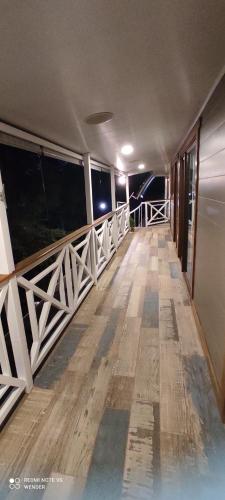 an empty balcony of a building with a wooden floor at Green House by W. in Heredia