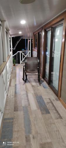 a balcony with a bench on a house at Green House by W. in Heredia