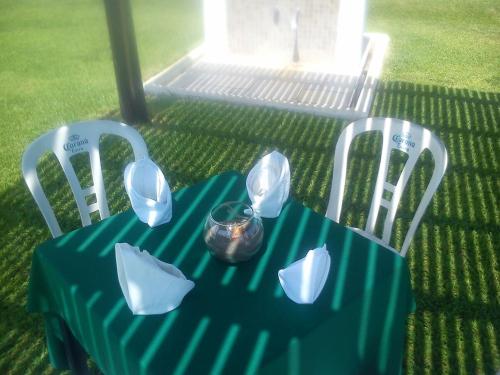 a table with a blue table cloth and two chairs at Hotel Arrecife Chachalacas in Chachalacas