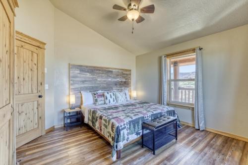 a bedroom with a bed and a ceiling fan at --30 mins to Zion--Two Cabins w/ Game Room--Bryce/Lake Powell/Grand Canyon in Kanab