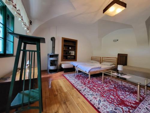 a living room with a bed and a table at Apartma 5 in Radovljica