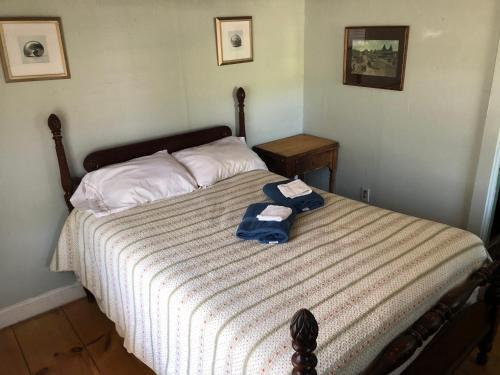 a bedroom with a bed with two towels on it at Seafarer Inn and Cottages in Old Orchard Beach