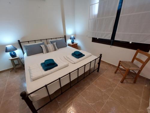 a bedroom with a large bed with two towels on it at Queens Gardens suite by the sea, pool and mall in Nea Paphos