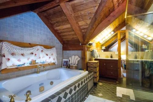 a large bathroom with a tub and a shower at Cowgirl Palace in Sag Harbor