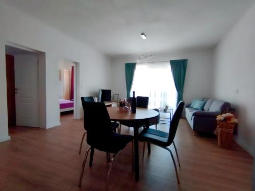 a living room with a table and chairs and a couch at Apartman, studio and room Kata in Pula
