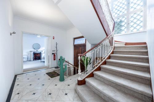 a staircase in a home with a glass window at Green Urban Oasis in Portimão