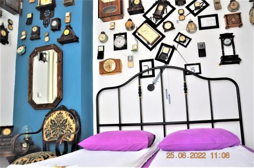 a room with a bed and a wall of pictures at Social Guest House in Sofia