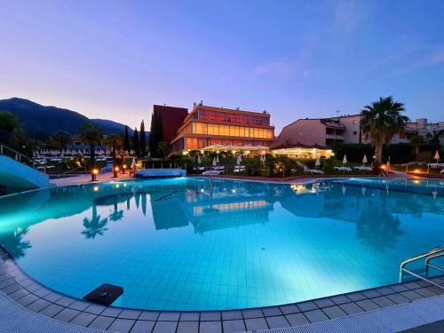 a large swimming pool in front of a building at Loano 2 Village in Loano