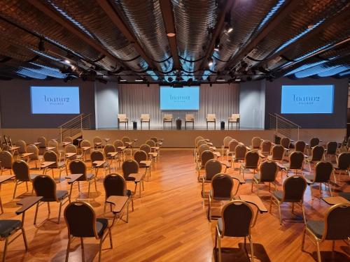 an empty hall with chairs and screens in the background at Loano 2 Village in Loano