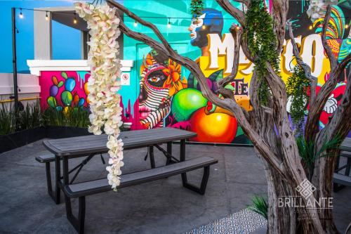 a bench sitting in front of a tree with flowers at Condominio Brillante GDL in Guadalajara