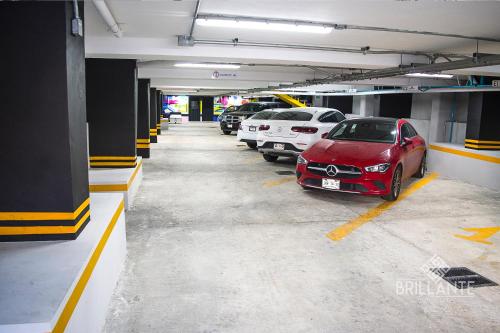 a parking garage with cars parked in it at Condominio Brillante GDL in Guadalajara