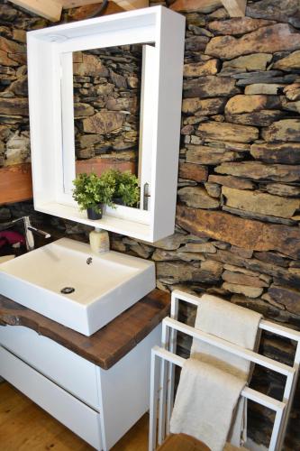 a bathroom with a sink and a mirror at Casa do Azereiro in Casal do Rei