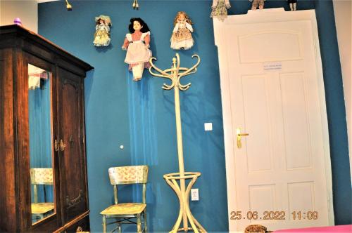 a room with a blue wall with dolls on the wall at Social Guest House in Sofia