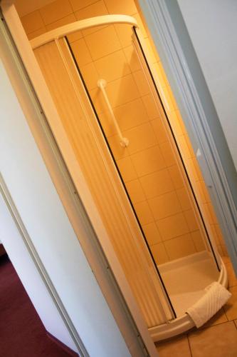 a mirror in a hallway with a band aid on it at Elita Hotel & Restauracja in Iwonicz-Zdrój