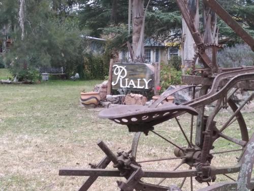 a chair in a yard with a sign in the background at Pualy Resort & Spa in Belén de Escobar