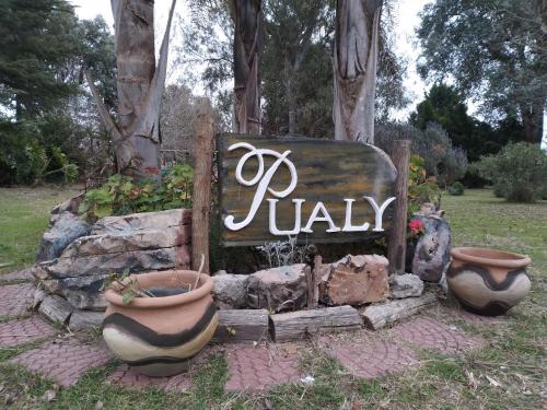 a sign that says riley with three pots in a yard at Pualy Resort & Spa in Belén de Escobar