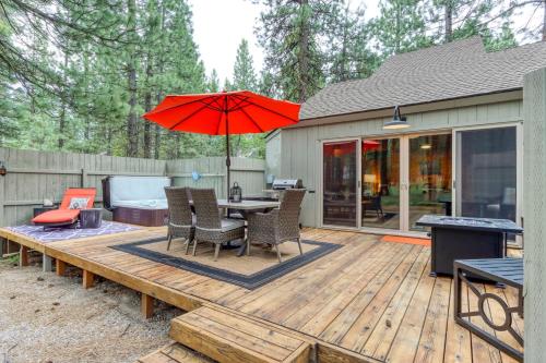 a wooden deck with a table and an umbrella at Lucky #7 in Black Butte Ranch